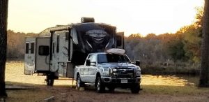 Awesome campsite in the Tombigbee National Forest right on Davis Lake with the sun setting behind my rig.