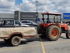 Farm tractor in WalMart parking lot.