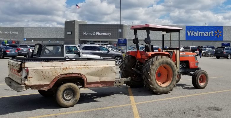 Farm tractor in WalMart parking lot.