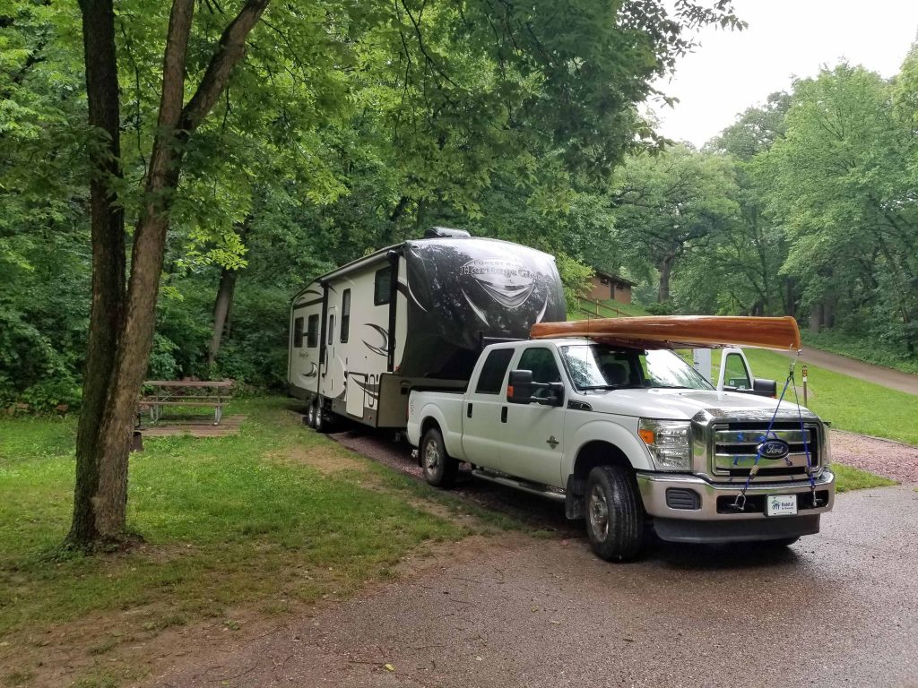 state park campground with RV parked in low cost camping site