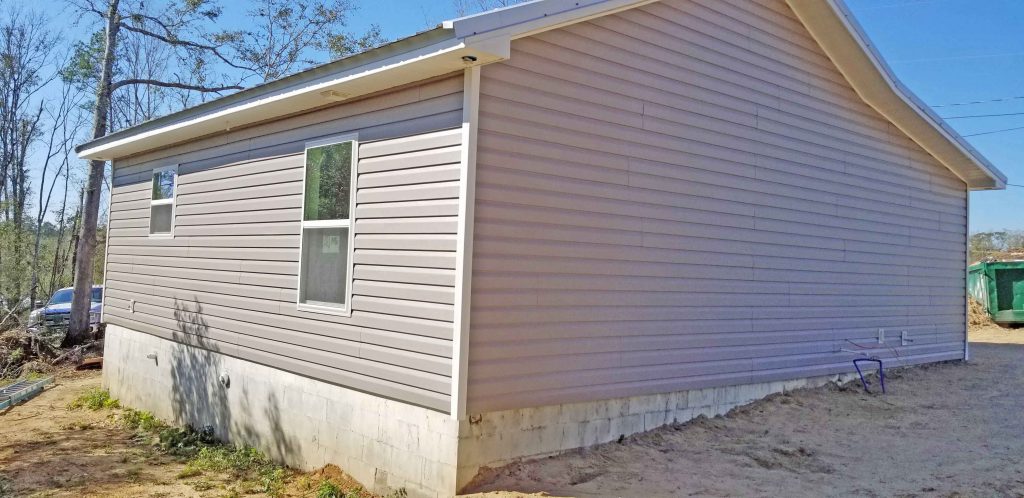 Habitat for Humanity RV Care-A-Vanners install vinyl siding