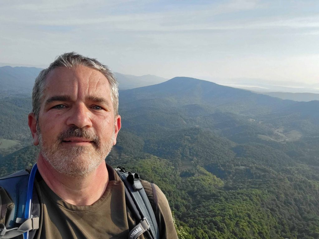 Brad Saum at McAfee Knob overlooking the Appalachian Mountains.