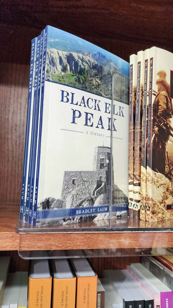 The book, Black Elk Peak by Brad Saum on a store shelf.