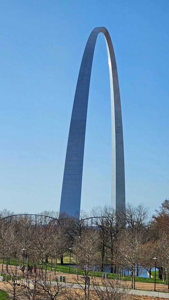 Jefferson National Expansion Memorial in St. Louis, Missouri against a blue sky.