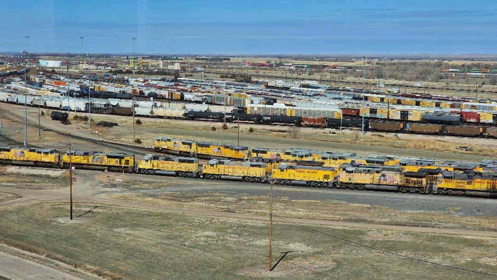 Union Pacific railyard with multiple trains and tracks.