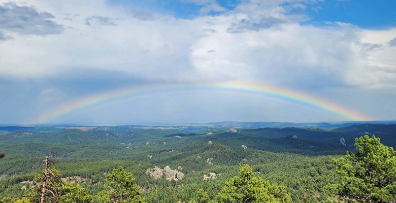 A full rainbow mover the Black Hills.