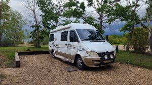 Camper van parked on gravel at Prairie Oasis Provincial Park in Alberta.