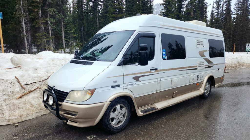 Van parked by snow bank at Bow Summit