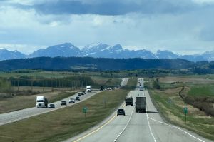 four lane divided highway in Canada leading to Banff National Park mountains and hiking trails