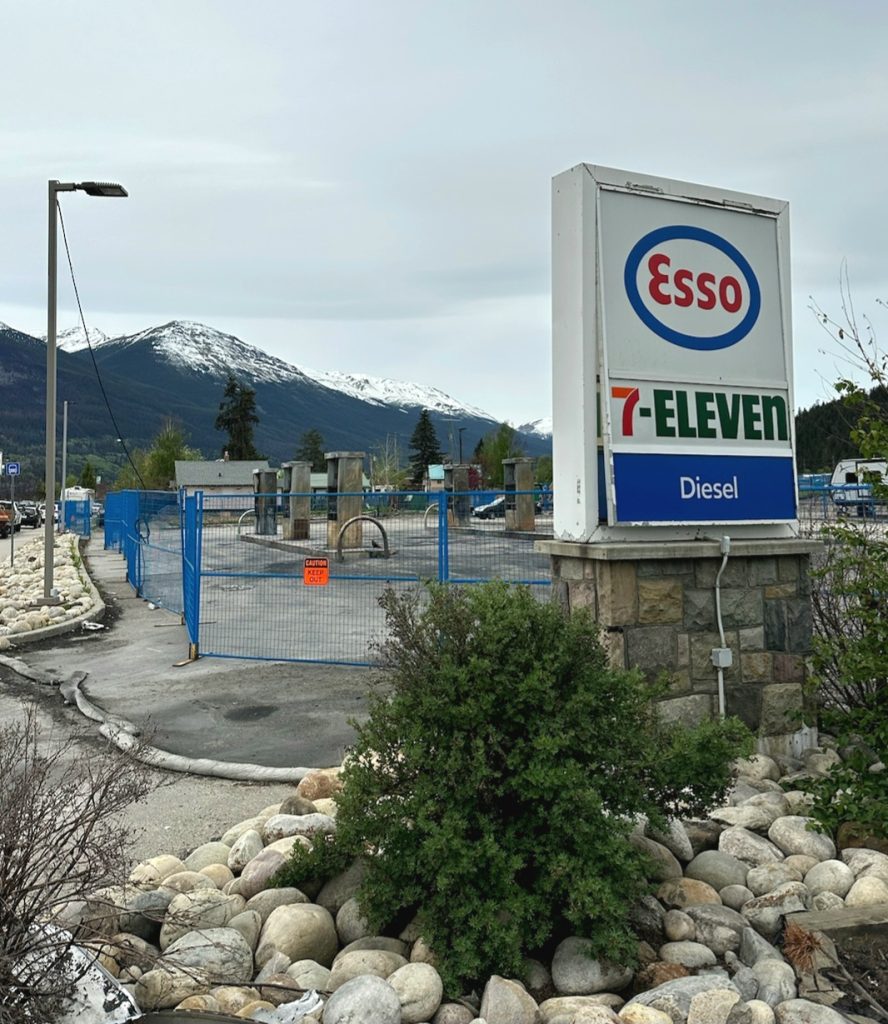 7-Eleven sign in Jasper at the end of the Icefields Parkway with evidence of fire damage.
