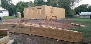 The house walls were framed when we arrived, and the roof trusses lay in front of the house ready to be installed.