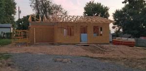 Our first task was setting the roof trusses on top of the house to support the roof.